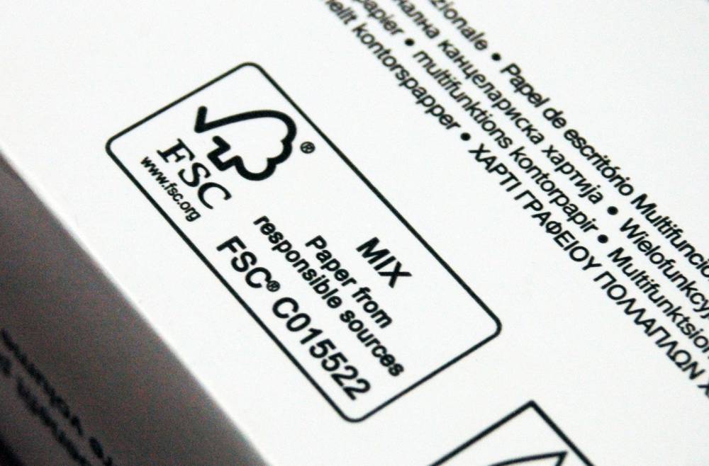 A close up stack of printer paper with the FSC certification logo shown.